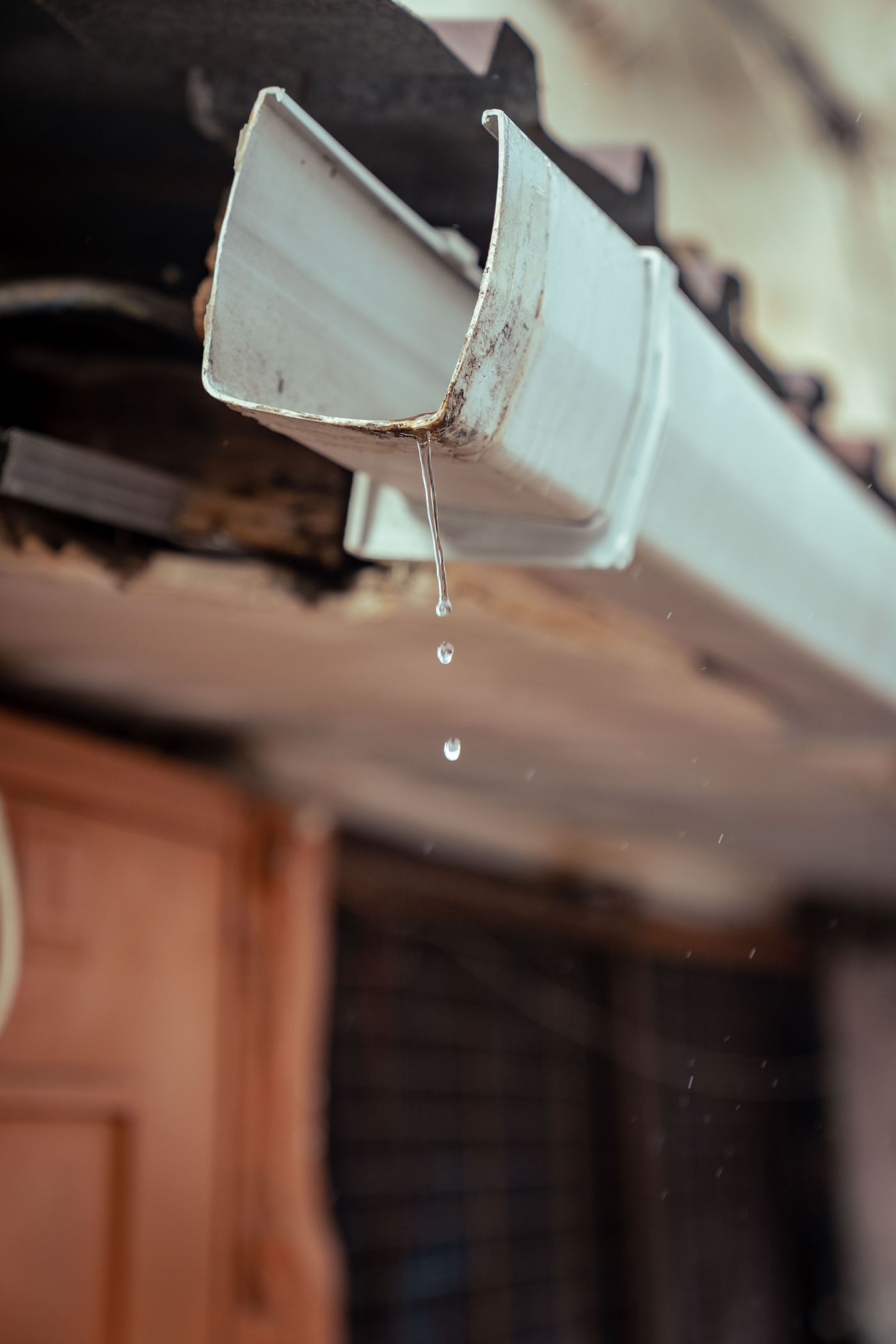A flat-roof drain and scupper cleared to stop ponding water